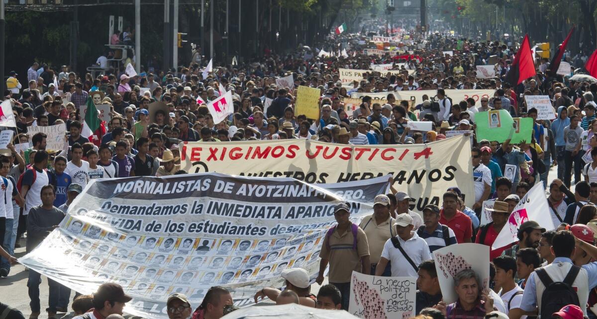 Thousands of protesters march in Mexico City on Oct. 8 to demand justice in the case of 43 students who went missing in Iguala, in Guerrero state.