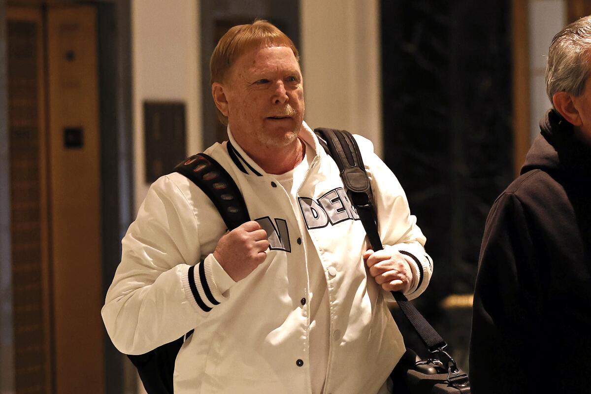 Raiders owner Mark Davis leaves the NFL owners meeting Wednesday in New York.