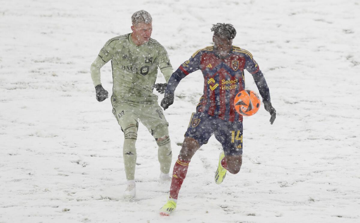 Real Salt Lake's Emeka Eneli controls the ball in front of LAFC midfielder Mateusz Bogusz.