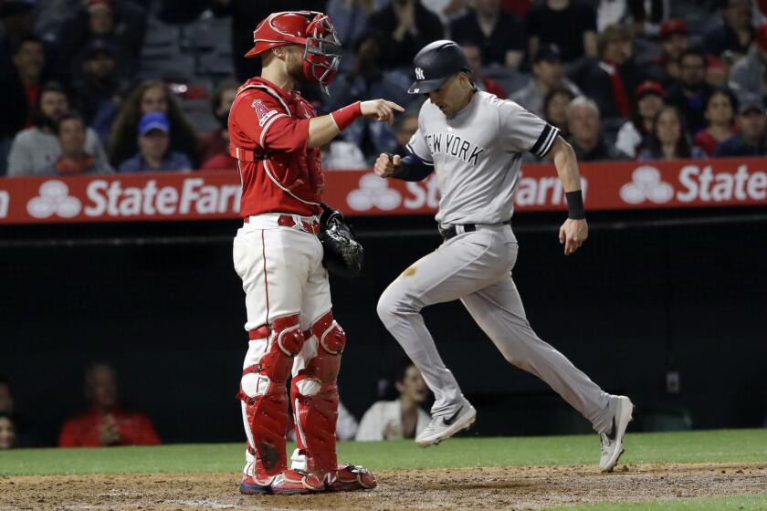 New York Yankees' Tyler Wade, right, scores on a single from DJ LeMahieu during the ninth inning of a baseball game against the Los Angeles Angels Wednesday, April 24, 2019, in Anaheim, Calif. (AP Photo/Marcio Jose Sanchez)