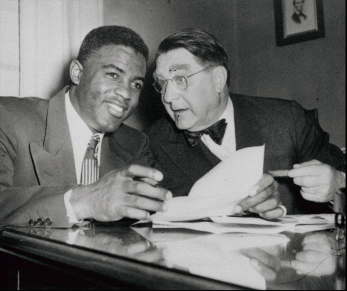 Jackie Robinson and Brooklyn GM Branch Rickey, who signed Robinson to play for the Dodgers.