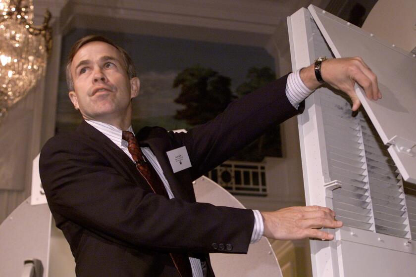 Scott Smith of B/E Aerospace Inc. shows the AeroGuard cockpit security system featuring an anti-ballistic cockpit door in October 2001.