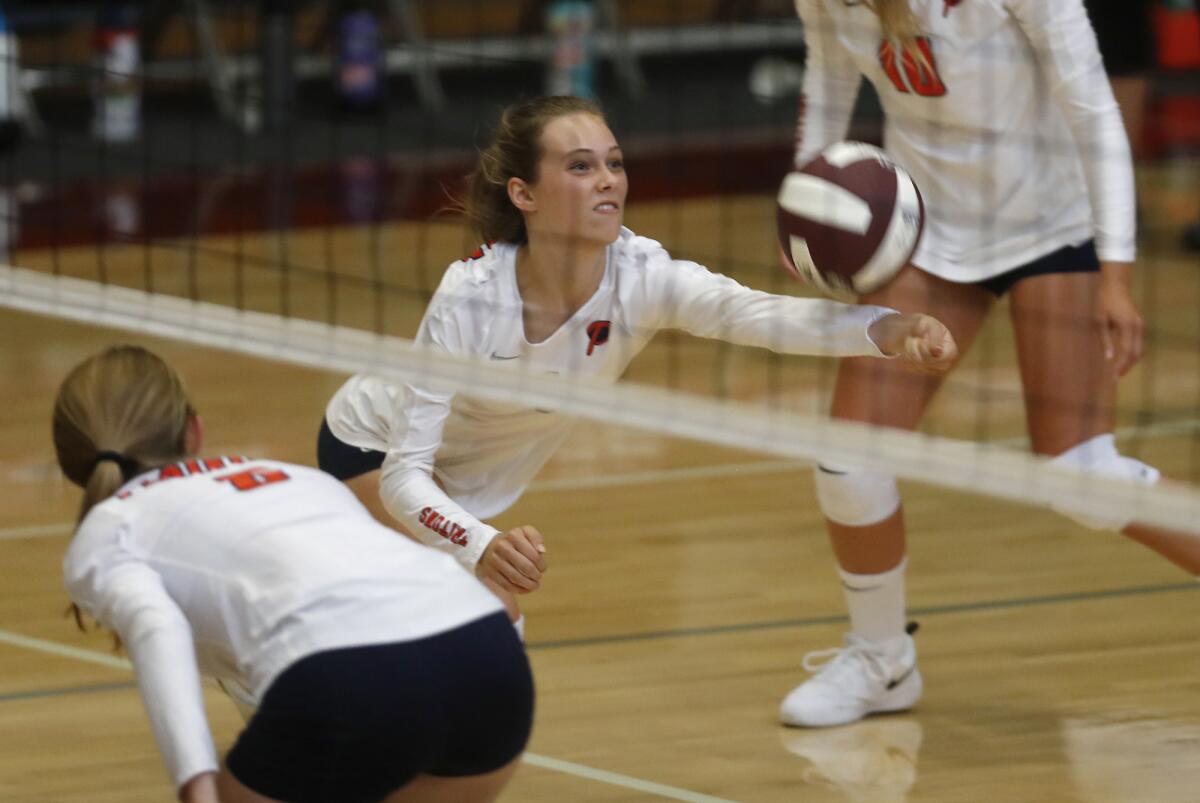 Pacifica Christian Orange County's Ava Loritz dives to keep the ball alive at Downey Calvary Chapel in the first set of a nonleague match on Tuesday.