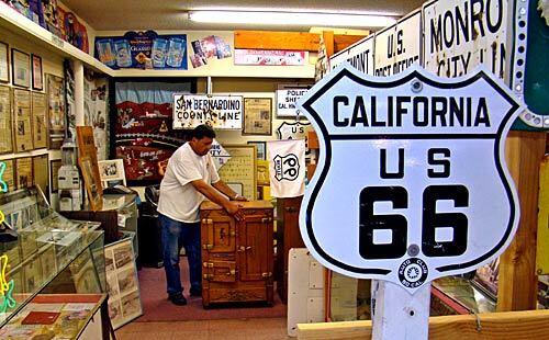 Danny Castro, an amateur historian and founding member of the California Historic Route 66 Assn., rearranges memorabilia at a museum he operates in San Bernardino.