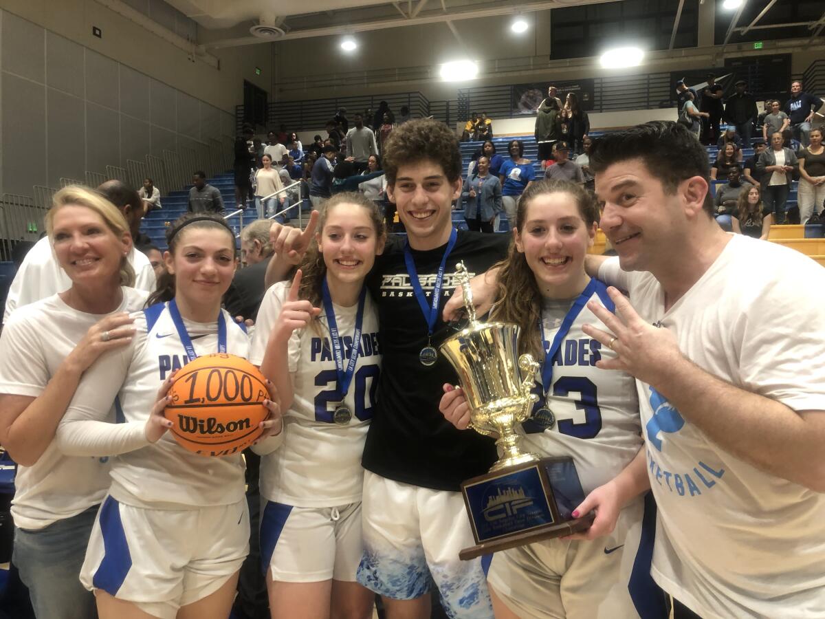 The Arnold family won four championship rings playing for Palisades on Saturday. Mother Stacey (left) celebrates championships for children Sammie, Elise, Caden and Taylor along with husband Michael.