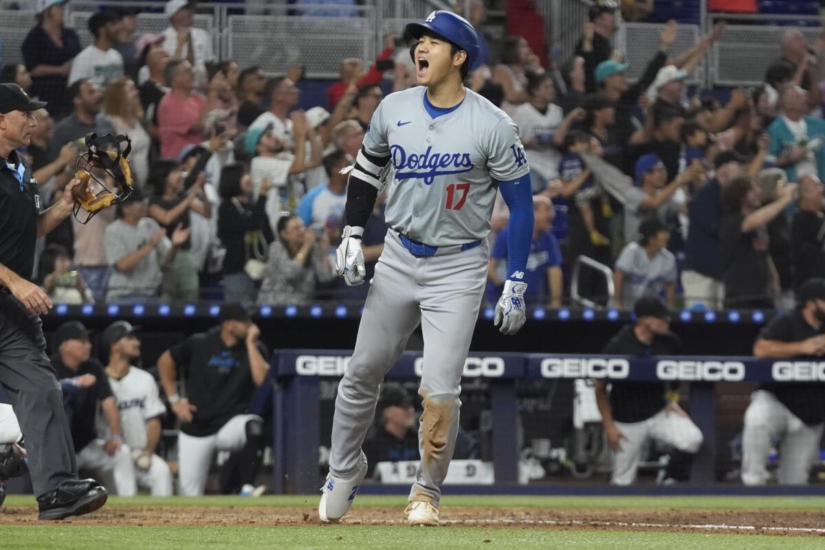 Dodgers star Shohei Ohtani celebrates after hitting his 50th home run of the season in a 20-4 win over the Miami Marlins.