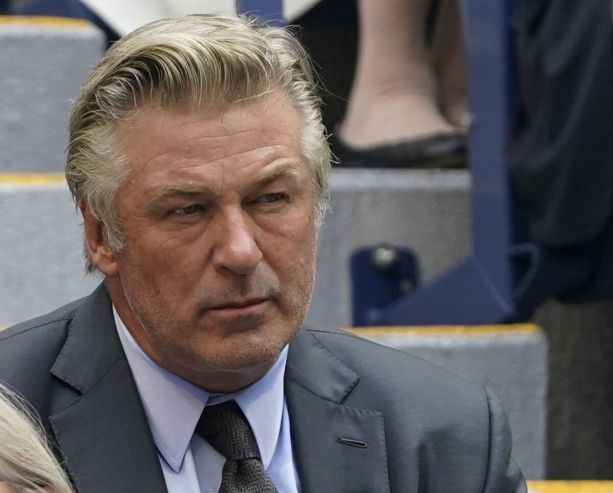 A close-up photo of Alec Baldwin in a suit and tie. 