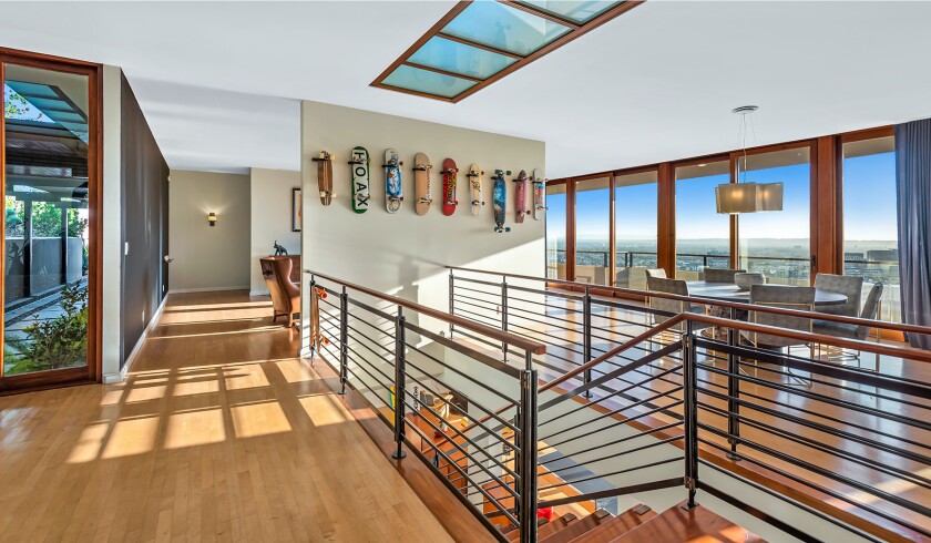 The hillside home includes three levels of decks, balconies and patios, as well as a swimming pool and spa.