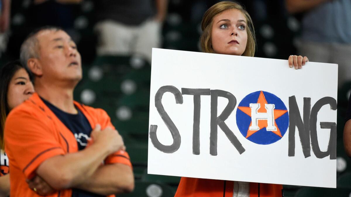 A fan shares her sentiments during the national anthem before the Houston Astros played the New York Mets in Houston on Saturday.