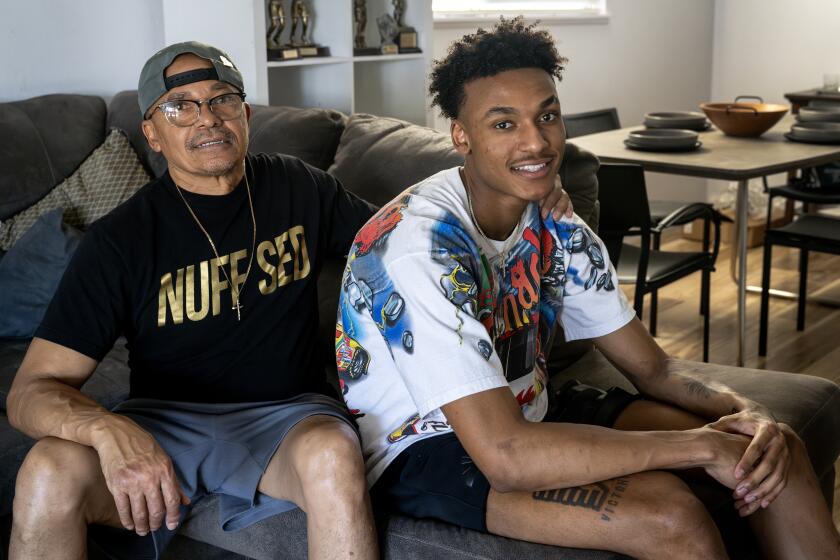 LAS VEGAS, NV - JULY 11, 2023: Lakers rookie Maxwell Lewis, right, spends time with his dad Robert Lewis.