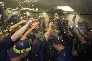 Texas Rangers players celebrate after beating the Tampa Bay Rays 7-1 during Game 2 in an AL wild-card baseball playoff series, Wednesday, Oct. 4, 2023, in St. Petersburg, Fla. (AP Photo/John Raoux)