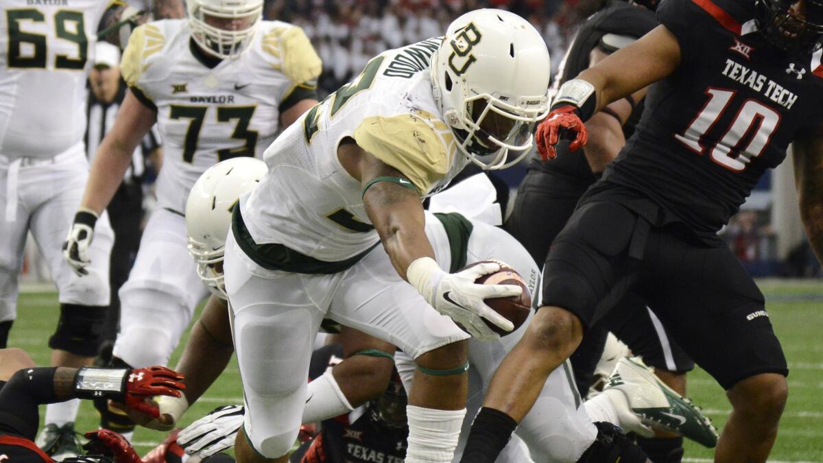 Baylor running back Shock Linwood scores a touchdown during the first half of a 48-46 win over Texas Tech on Saturday.