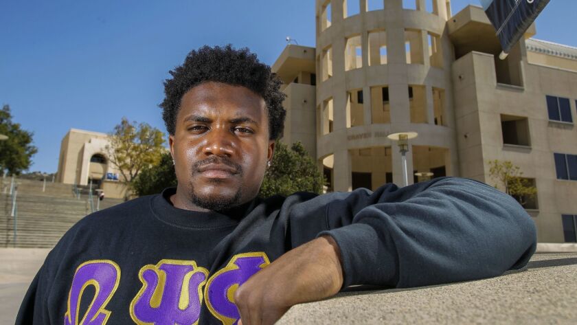 Dwaine Collier Jr., 22, who graduates from Cal State San Marcos today, poses near Craven Hall on campus this week.