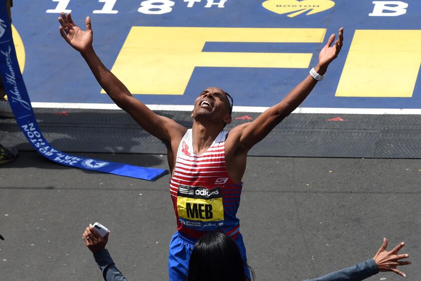 Men's Elite division winner Meb Keflezighi of the US reacts as he crosses the finish line during the 118th Boston Marathon in Boston, Massachusetts April 21, 2014 . AFP PHOTO / Timothy A. CLARY (Photo credit should read TIMOTHY A. CLARY/AFP via Getty Images)