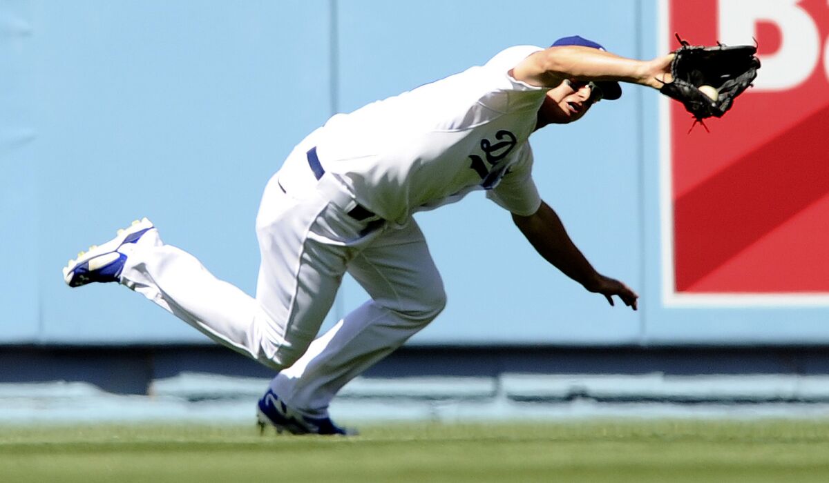 Dodgers center fielder Joc Pederson makes a diving catch on a ball hit by Padres third baseman Will Middlebrooks during the season opener on April 6.