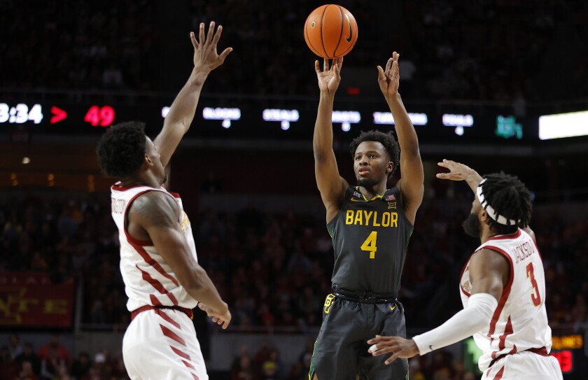 Baylor guard LJ Cryer (4) shoot a three point basket as Iowa State guards Izaiah Brockington (1) and Tre Jackson (3) defend during the second half of an NCAA college basketball game, Saturday, Jan. 1, 2022, in Ames, Iowa. Baylor won 77-72. (AP Photo/Matthew Putney)