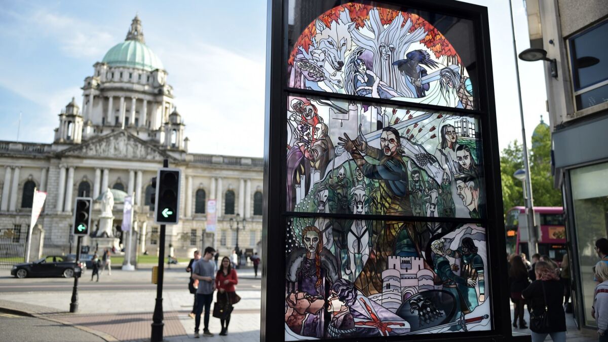 A stained glass art installation in front of Belfast City Hall depicts scenes from "Game of Thrones."