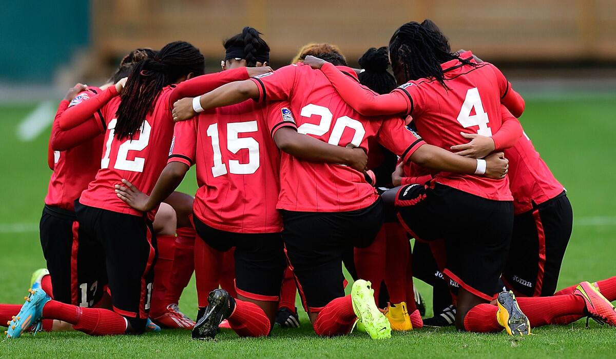 Trinidad and Tobago women's soccer players huddle before their CONCACAF game against Guatemala on Monday in Washington.