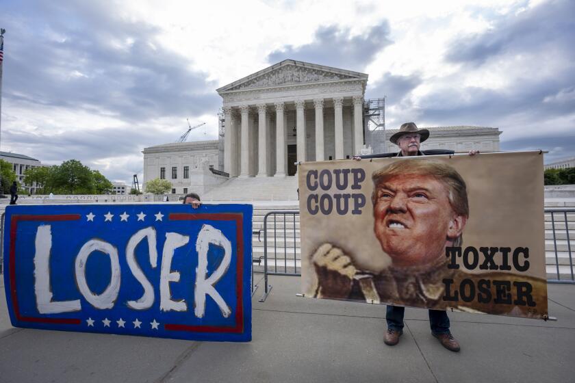 Activist Stephen Parlato of Boulder, Colo., right, joins other protesters outside the Supreme Court as the justices prepare to hear arguments over whether Donald Trump is immune from prosecution in a case charging him with plotting to overturn the results of the 2020 presidential election, on Capitol Hill in Washington, Thursday, April 25, 2024. (AP Photo/J. Scott Applewhite)