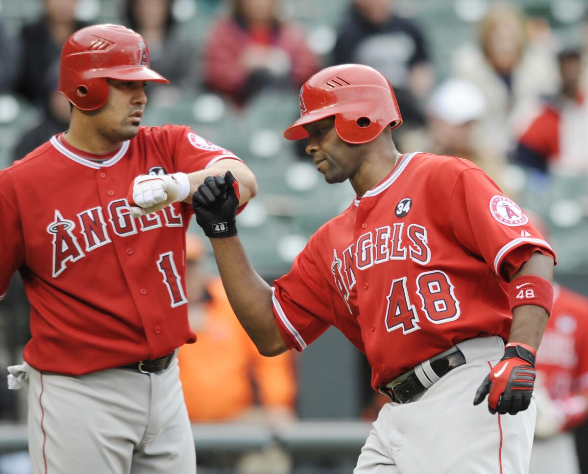 Angels' Torii Hunter, right, gets a fist bump from Kendrys Morales after hitting a home run.
