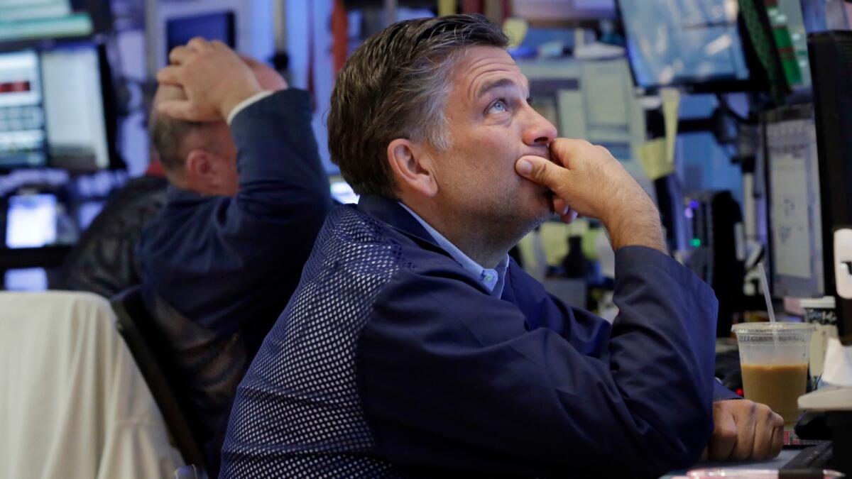 Trader Jeffrey Lucchesi works on the floor of the New York Stock Exchange on June 27.