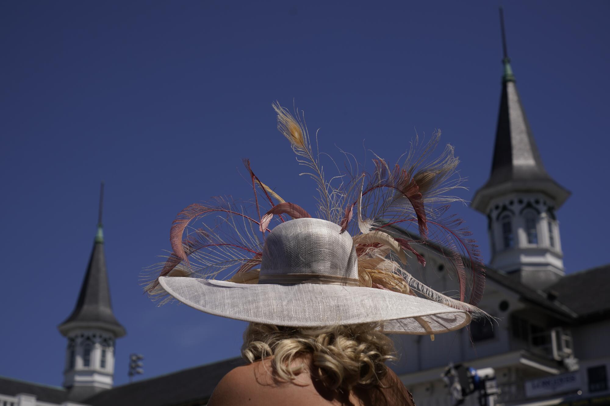 A woman stands in the paddock before the 147th running of the Kentucky Derby at Churchill Downs on Saturday.