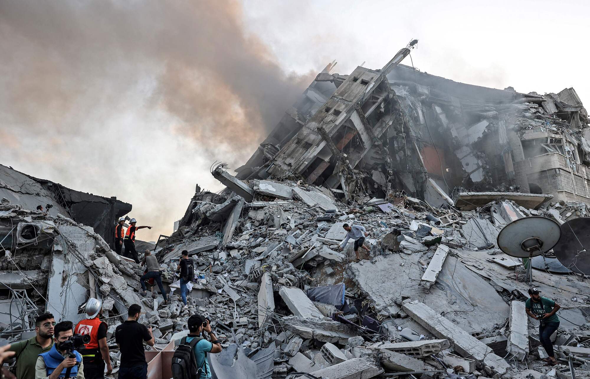People stand amid rubble.
