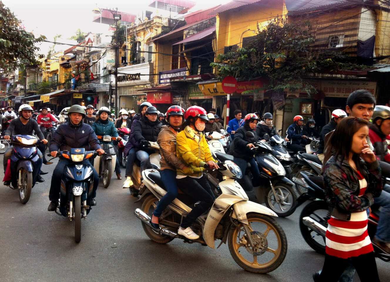 Motor scooters race through the hectic, narrow streets of Hanoi's Old Quarter. Scooters are the main mode of transport in Hanoi, and drivers stop for no one. Want to cross the street? Do as the locals do and step directly into the fray.