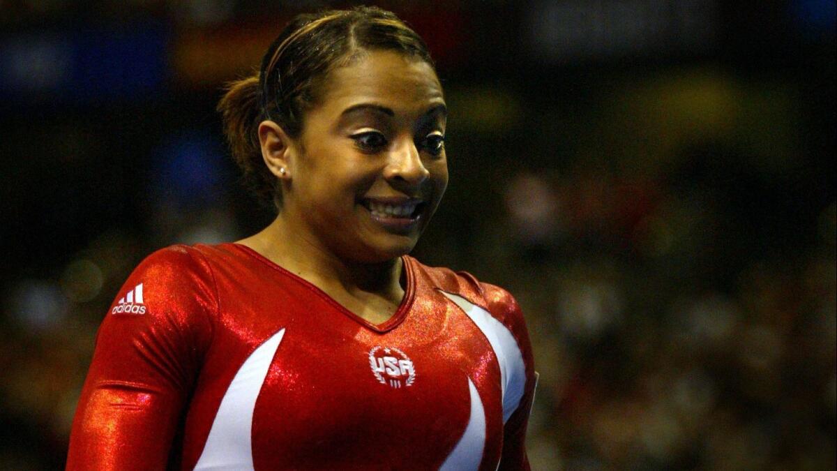 Tasha Schwikert reacts after competing in the uneven bars at the 2003 world gymnastics championships.