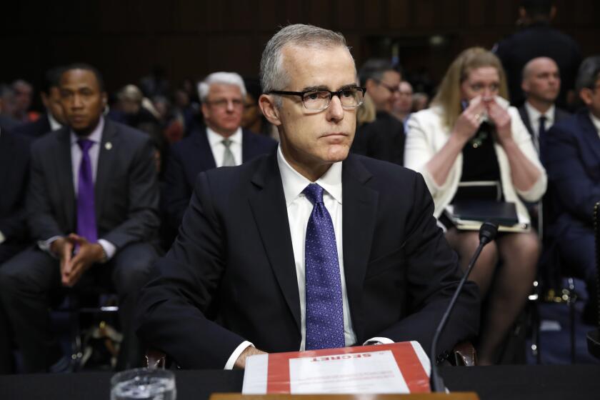 Acting FBI Director Andrew McCabe sits with a folder marked "Secret" in front of him while testifying on Capitol Hill in Washington on Thursday.