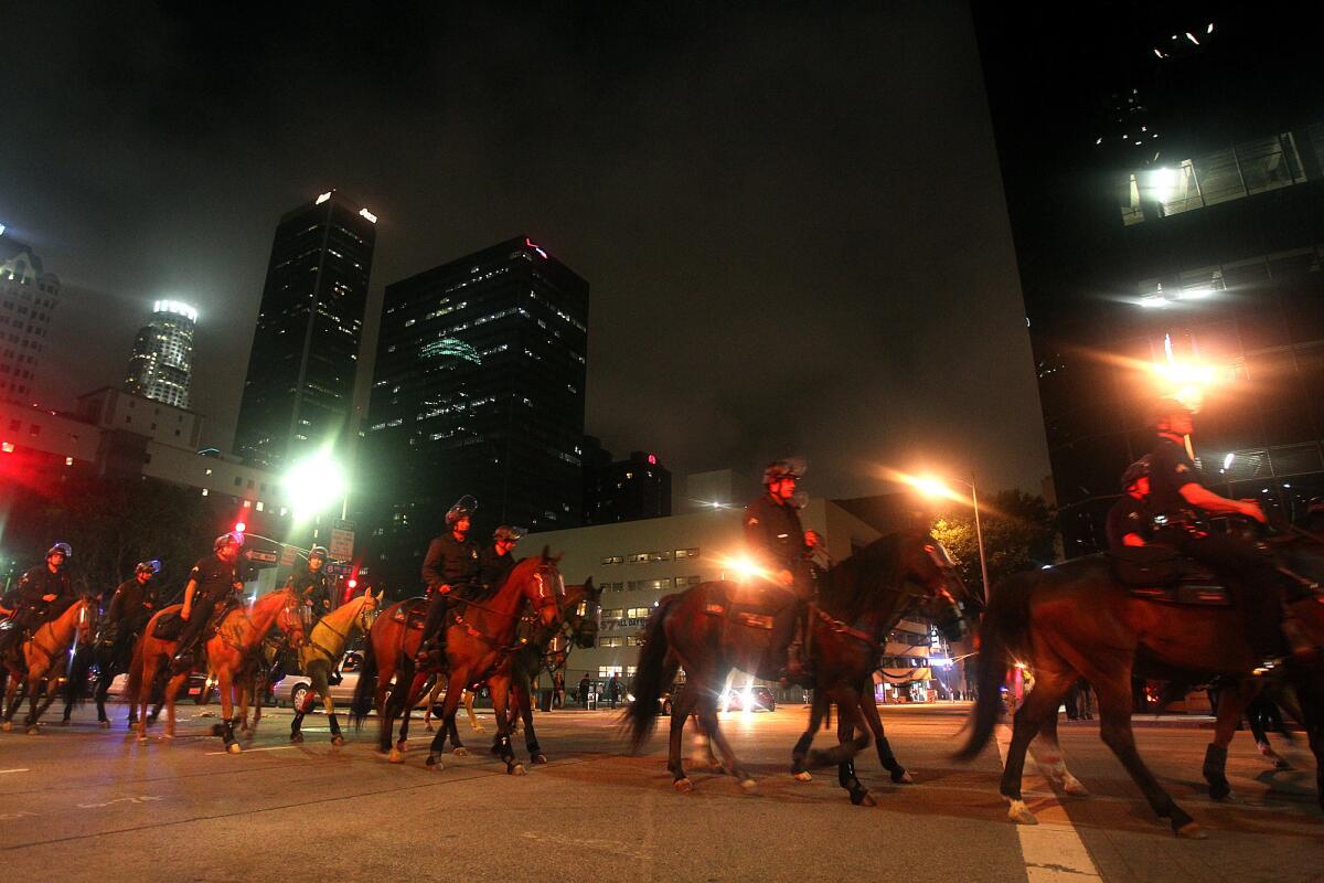 Police on horses walk down Figueroa Street in downtown Los Angeles after the Kings' 2012 Stanley Cup victory.