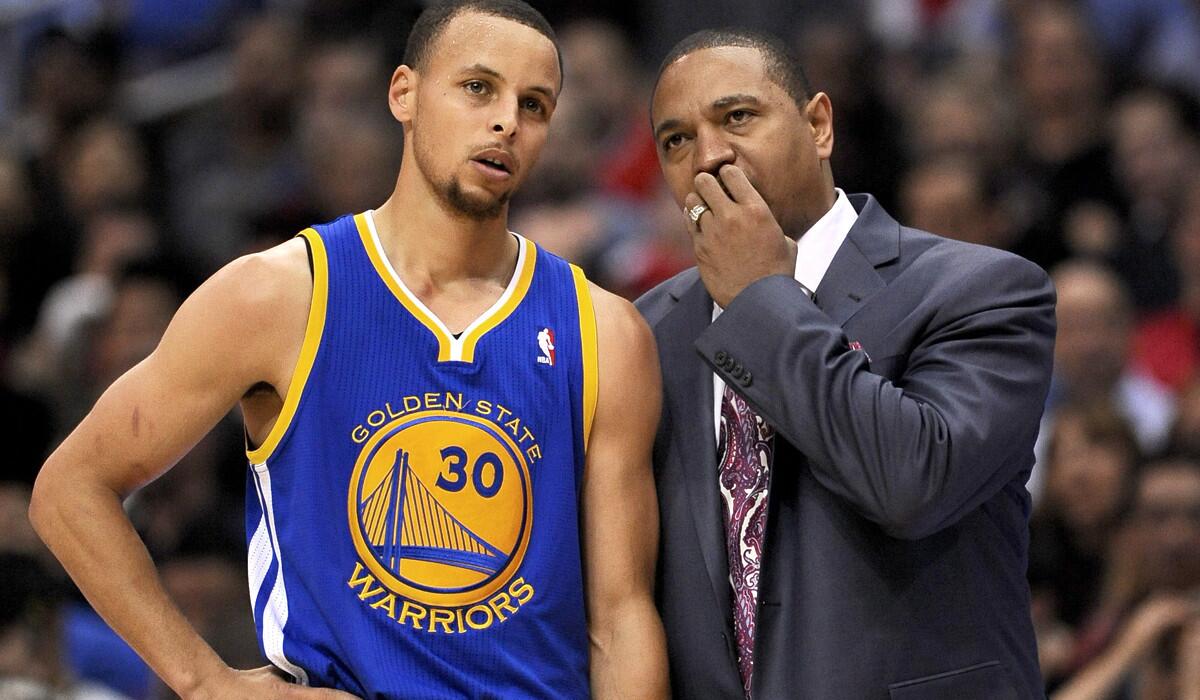 Warriors Coach Mark Jackson confers with All-Star point guard Stephen Curry (30) during the first quarter of a playoff game against the clippers on Tuesday at Staples Center.
