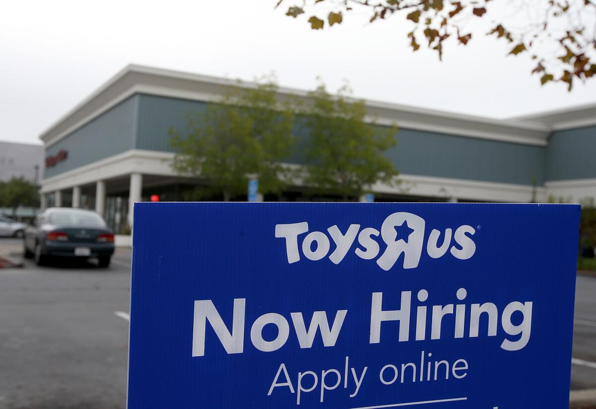 A "Now Hiring" sign is posted in front of a Toys R Us store in San Rafael, Calif., on Nov. 7.