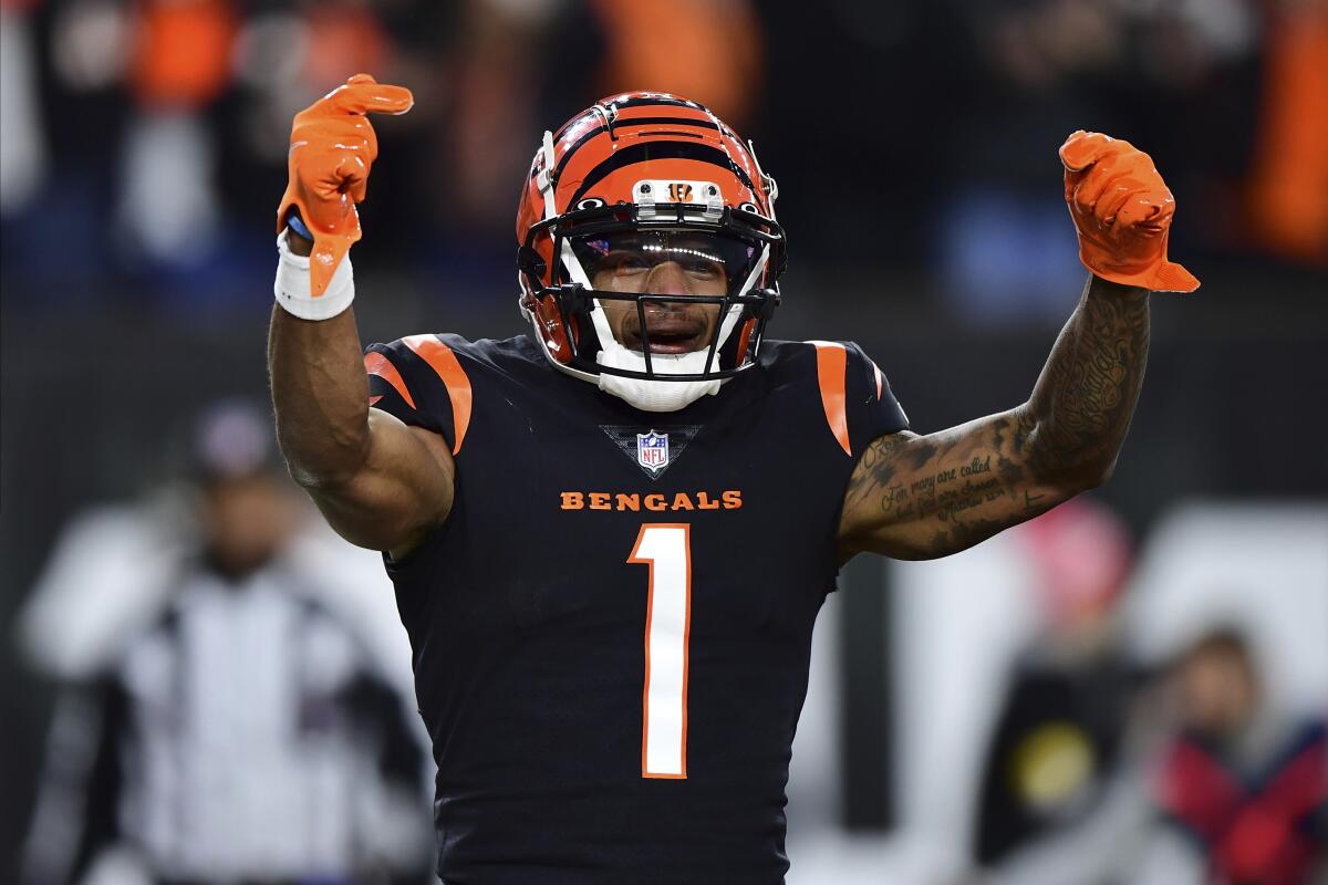 Cincinnati Bengals receiver Ja'Marr Chase motions with both arms lifted and index fingers pointed