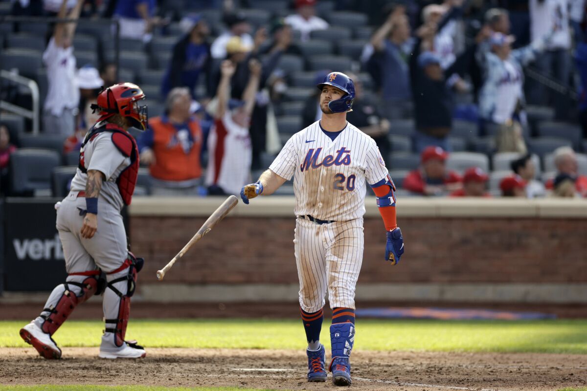 New York Mets' Pete Alonso reacts after hitting a walk-off two-run home run in the 10th inning of a baseball game as St. Louis Cardinals catcher Yadier Molina (4) walks off the field on Thursday, May 19, 2022, in New York. The Mets won 7-6 in 10 innings. (AP Photo/Adam Hunger)
