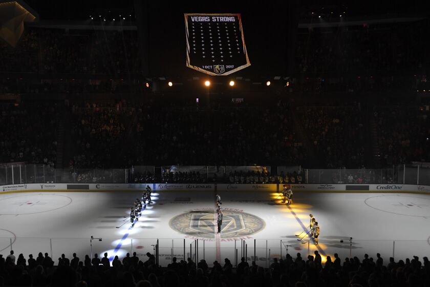 FILE - A moment of silence is held inside T-Mobile Arena honoring the fourth anniversary of the Las Vegas shooting before an NHL preseason hockey game between the Vegas Golden Knights and the Los Angeles Kings Friday, Oct. 1, 2021, in Las Vegas. The Vegas Golden Knights and Florida Panthers were connected by tragedy five years before meeting in the Stanley Cup Final. (AP Photo/David Becker, File)
