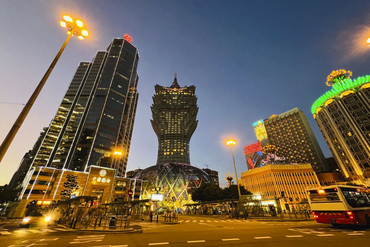 Grand Lisboa, center, is closed in Macao, Monday, July 11, 2022. Streets in the gambling center of Macao were empty Monday after casinos and most other businesses were ordered to close while the Chinese territory near Hong Kong fights a coronavirus outbreak. (AP Photo/Kong)