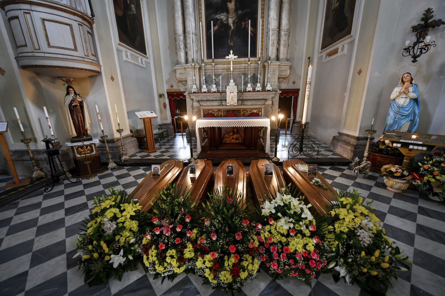 Italy: Coffins wait to be transported to a cemetery in a church in northern Italy.