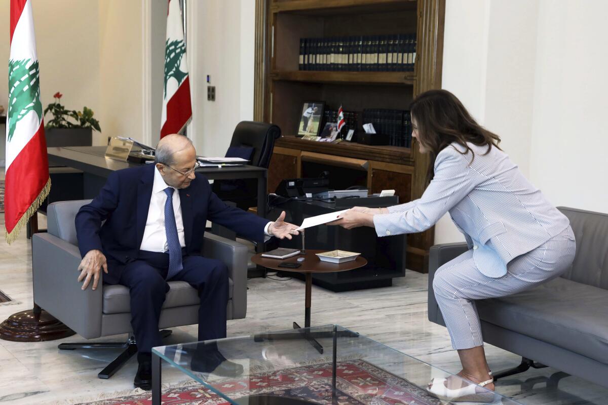 In this photo released by Lebanon's official government photographer Dalati Nohra, Lebanese president Michel Aoun, left, meets with U.S. Ambassador to Lebanon Dorothy Shea, at the Presidential Palace in Baabda, east of Beirut, Lebanon, Saturday, Oct. 1, 2022. Shea delivered a maritime border demarcation proposal to Lebanese President Michel Aoun on Saturday, as negotiations with Israel continue to progress. (Dalati Nohra via AP)