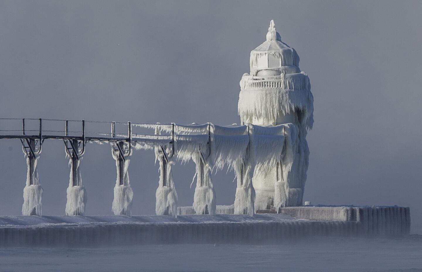 Extreme cold conditions cause ice accretions to cover the St. Joseph lighthouse and pier, on the southeastern shoreline of Lake Michigan.