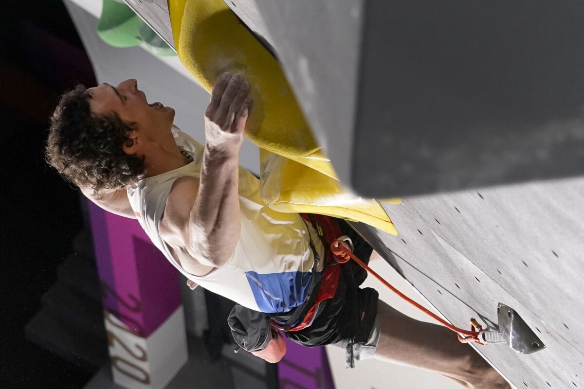 Adam Ondra, of the Czech Republic, yells as he participates during the lead qualification portion of the men's sport climbing competition at the 2020 Summer Olympics, Tuesday, Aug. 3, 2021, in Tokyo, Japan. (AP Photo/Jeff Roberson, POOL)