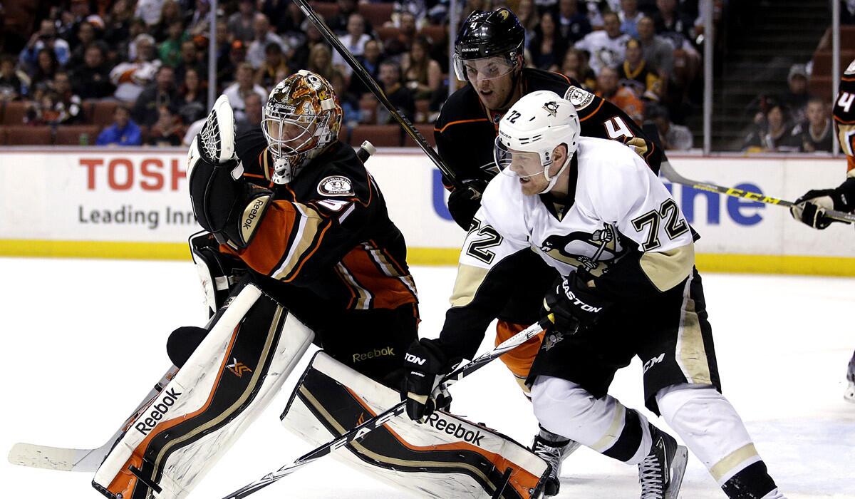 Ducks' goalie Frederik Andersen, left, makes a save as Cam Fowler and Penguins' Patric Hornqvist, right, watch during the Penguins' 5-2 victory over the Ducks on Friday.