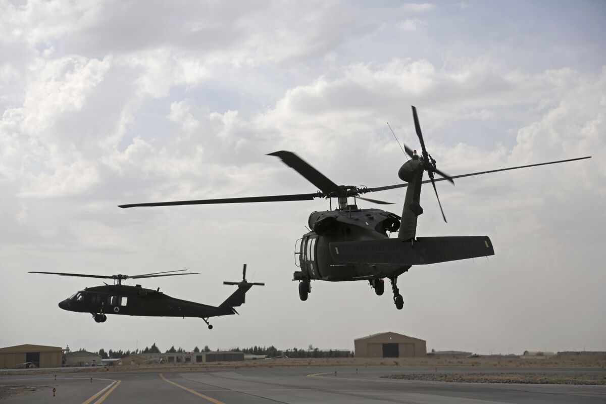 FILE - A view of UH-60 Black Hawk helicopters carrying U.S. and Afghan trainees take off at Kandahar Air Field, in Afghanistan, Monday, March 19, 2018. The United States has delivered two Black Hawk helicopters to Croatia amid a mini arms race with neighboring Russian ally Serbia and simmering tensions in the post-war Balkan region. The U.S. Embassy in Croatia’s capital, Zagreb, said Thursday, Feb. 3, 2022, the UH-60M multi-purpose helicopters will contribute to Croatia’s growing defense capabilities and military preparedness in support of NATO. (AP Photo/Rahmat Gul, File)