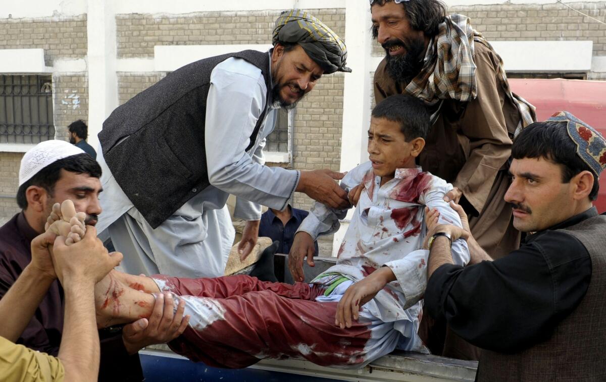 Men carry an injured youth outside a hospital following a shooting attack in the Pakistani city of Quetta.