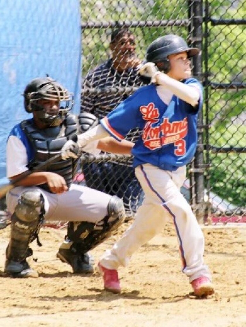 Angels infielder Andrew Velazquez bats while playing young baseball as a child.