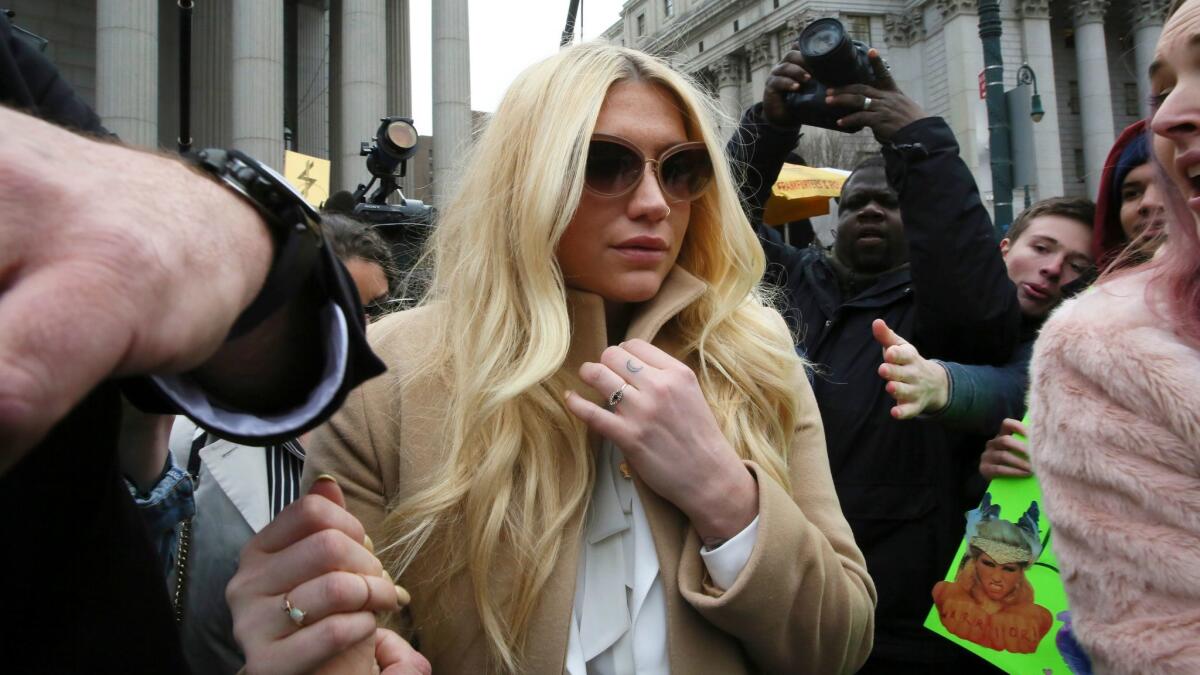 In this Feb. 19, 2016, file photo, pop star Kesha leaves the Supreme Court in New York after a hearing involving her producer, Dr. Luke.
