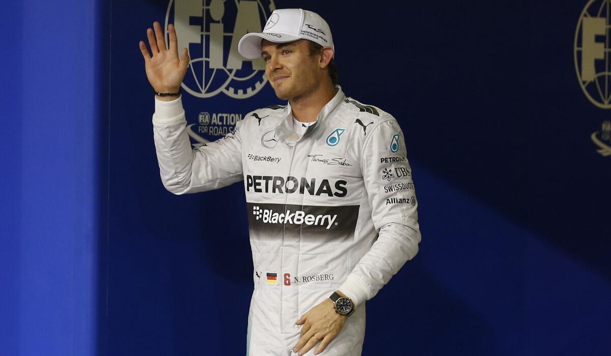 Formula One driver Nico Rosberg acknowledges fans after earning the pole position in the qualifying session for the Formula One race in Abu Dhabi.