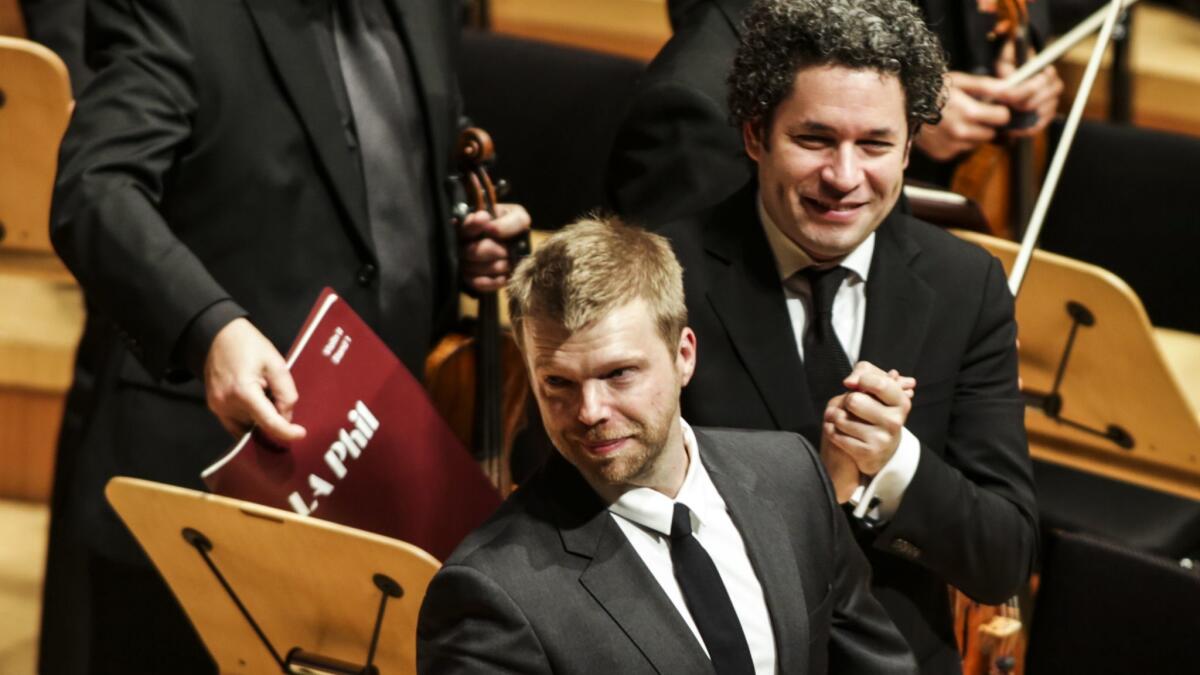 Andrew Norman bows at the end of his master composition at Walt Disney Concert Hall for the Los Angeles Philharmonic's new season.