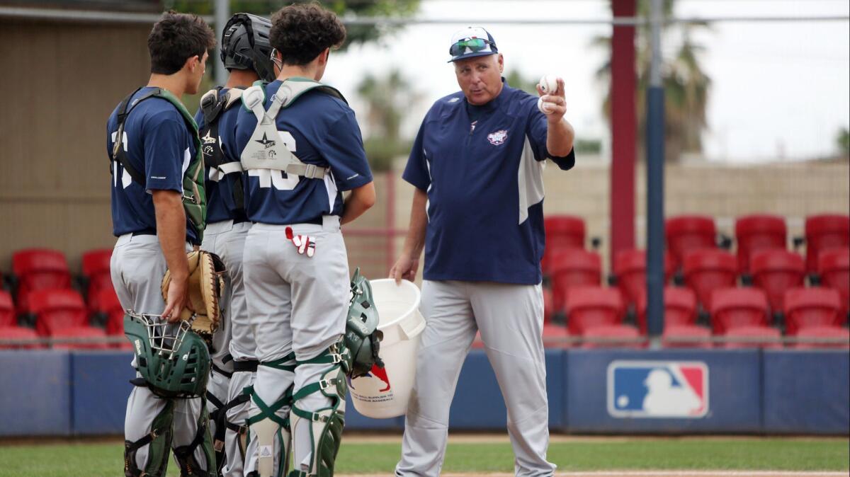 ’Mike Scioscia directs catchers at the Major League Baseball Youth Academy.