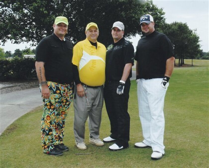 In this undated photo provided by the Wallace family, from left, Christopher Wallace, George Wallace, Matthew Wallace and Jonathan Wallace are shown at a golf course. Christopher and Jonathan Wallace are not out just playing 18 holes a day, they're part of a growing number of military veterans learning the golf business in hopes the game becomes their next career. The Wallace brothers and their father, George, are enrolled at the Golf Academy of America. (AP Photo/Wallace Family)